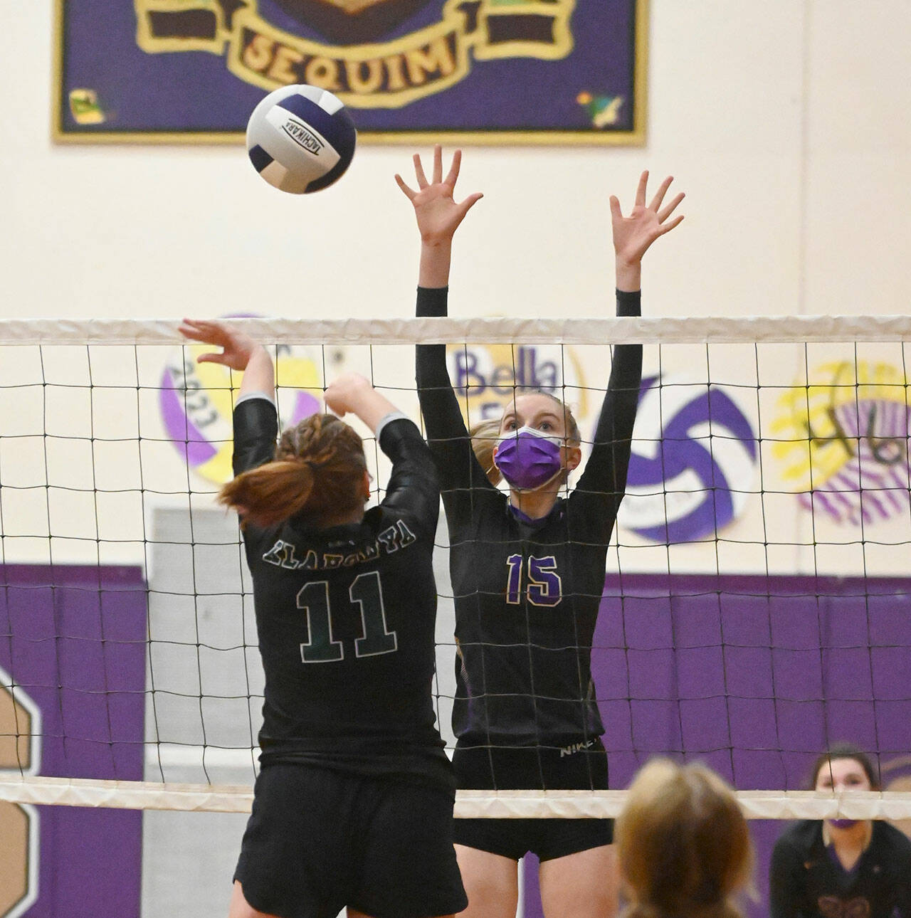 Sequim’s Kendall Hastings, right, looks for a block in an Olympic League match against Klahowya in February. Sequim Gazette file photo by Michael Dashiell