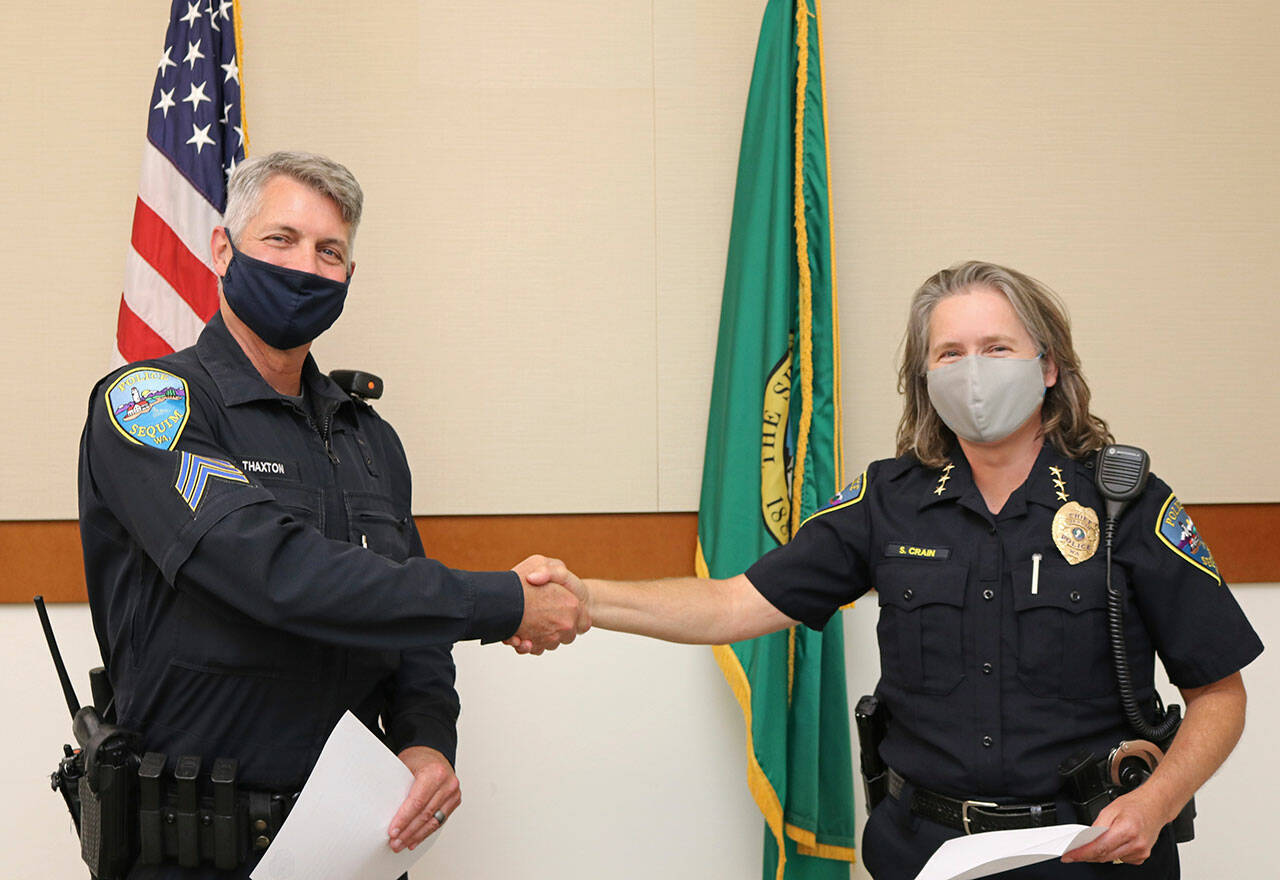 Jeff Thaxton accepts a promotion to patrol sergeant from Sequim Police Chief Sheri Crain. Photos courtesy of City of Sequim
