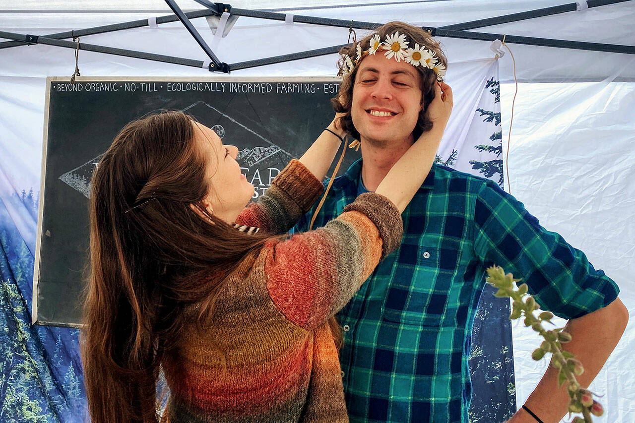 Rachel Shyles and her husband Dan enjoy a day at their Wildling Farm booth at the Sequim Farmers & Artisans Market. Photo by Emma Jane Garcia
