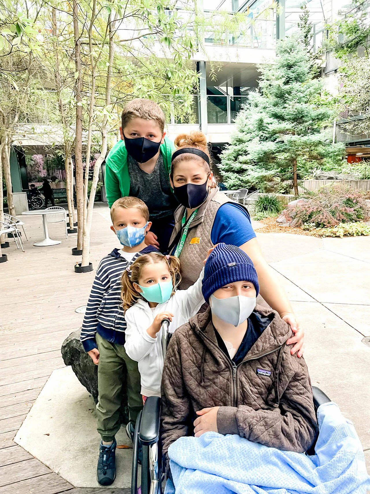 Five of the members of 6 person Ake family pose outside the Seattle Children’s hospital. Emerson Ake, in the front, is battling leukemia with quiet courage and good humor and his family temporarily moved from Sequim to stay together. Photo courtesy of the Ake family