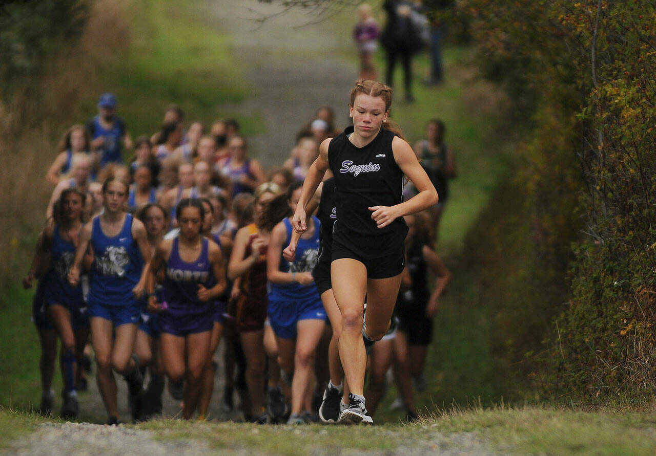 Sequim’s Riley Pyeatt leads the pack at the outset of an Olympic League meet on Sept. 29 at the Dungeness Recreation Area. Pyeatt cruised to a win by nearly 50 seconds. Sequim Gazette photo by Michael Dashiell