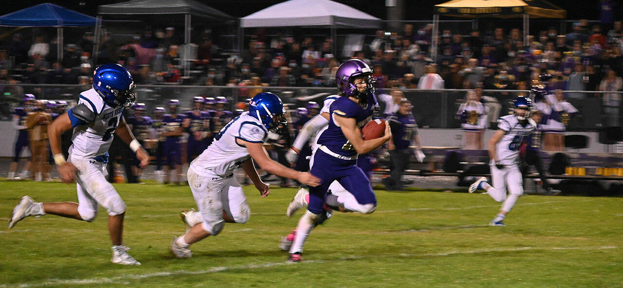 Sequim’s Aiden Gockerell breaks free for a big gain in the Wolves’ 29-28 win over North Mason on Oct. 16. Sequim Gazette photo by Michael Dashiell