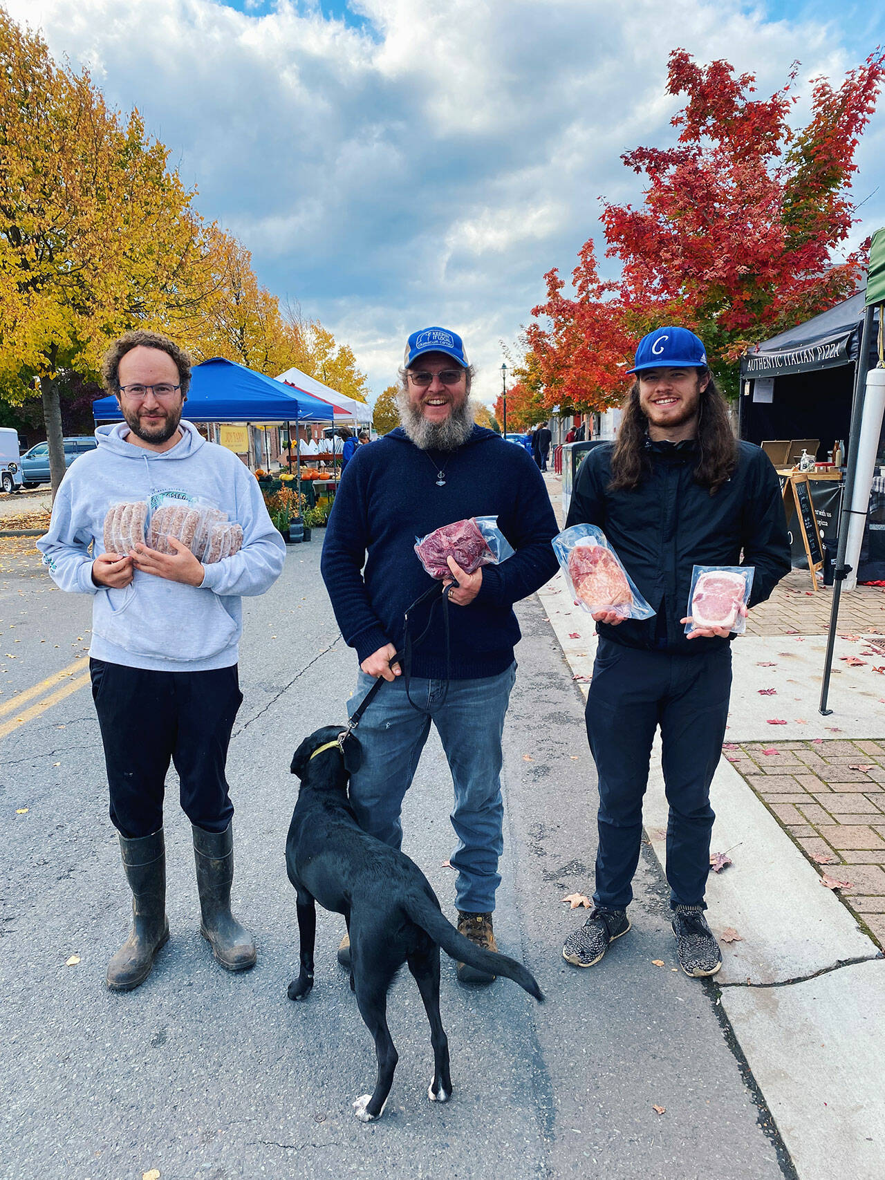 From left, Foggy Hog Farm owner Alex Lemay and crew members Sage Vann and Cole Dotson display some of the farm’s products at the Sequim Farmers & Artisans Market Saturday. Photos by Emma Jane Garcia
