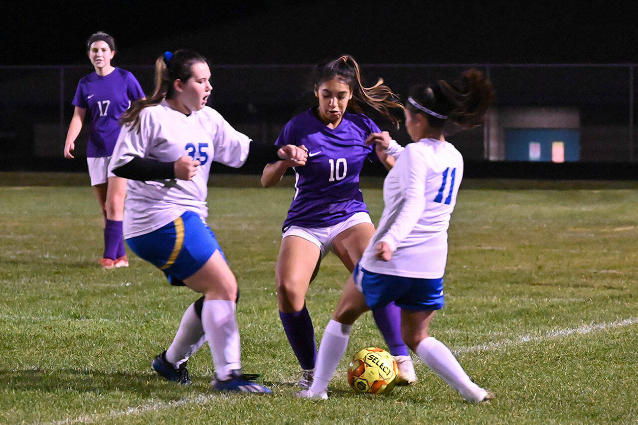 With teammate Kaia Lestage (left) looking on, Sequim’s Jennyfer Gomez vies for possession in the Wolves’ 6-0 win Tuesday night against visiting Bremerton. Sequim Gazette photos by Michael Dashiell