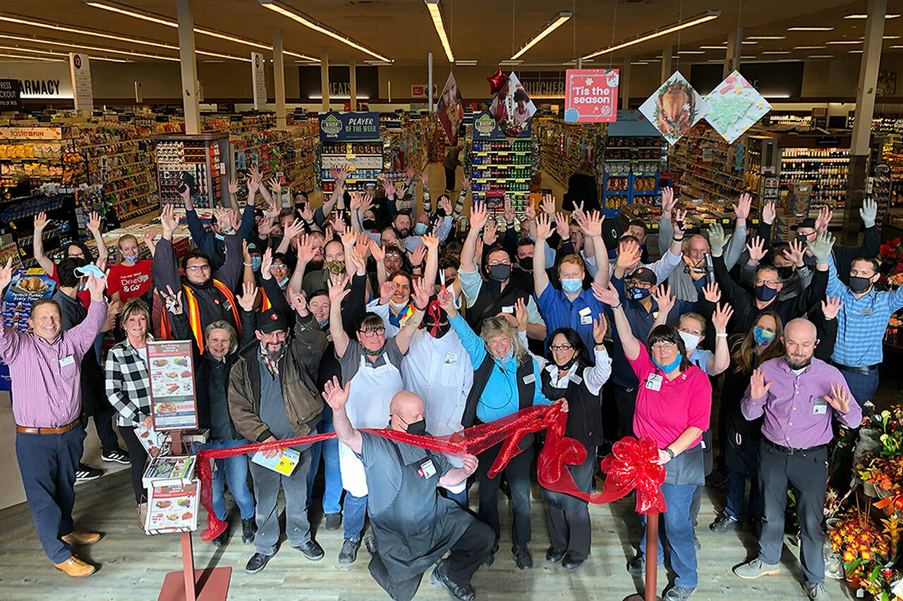 Staff gather for a ribbon cutting at the “Grand Reopening” of the Sequim Safeway on Oct. 27. The store was remodeled in recent months, its first since 2004, staff said. Photo courtesy of Isaac Peiffer