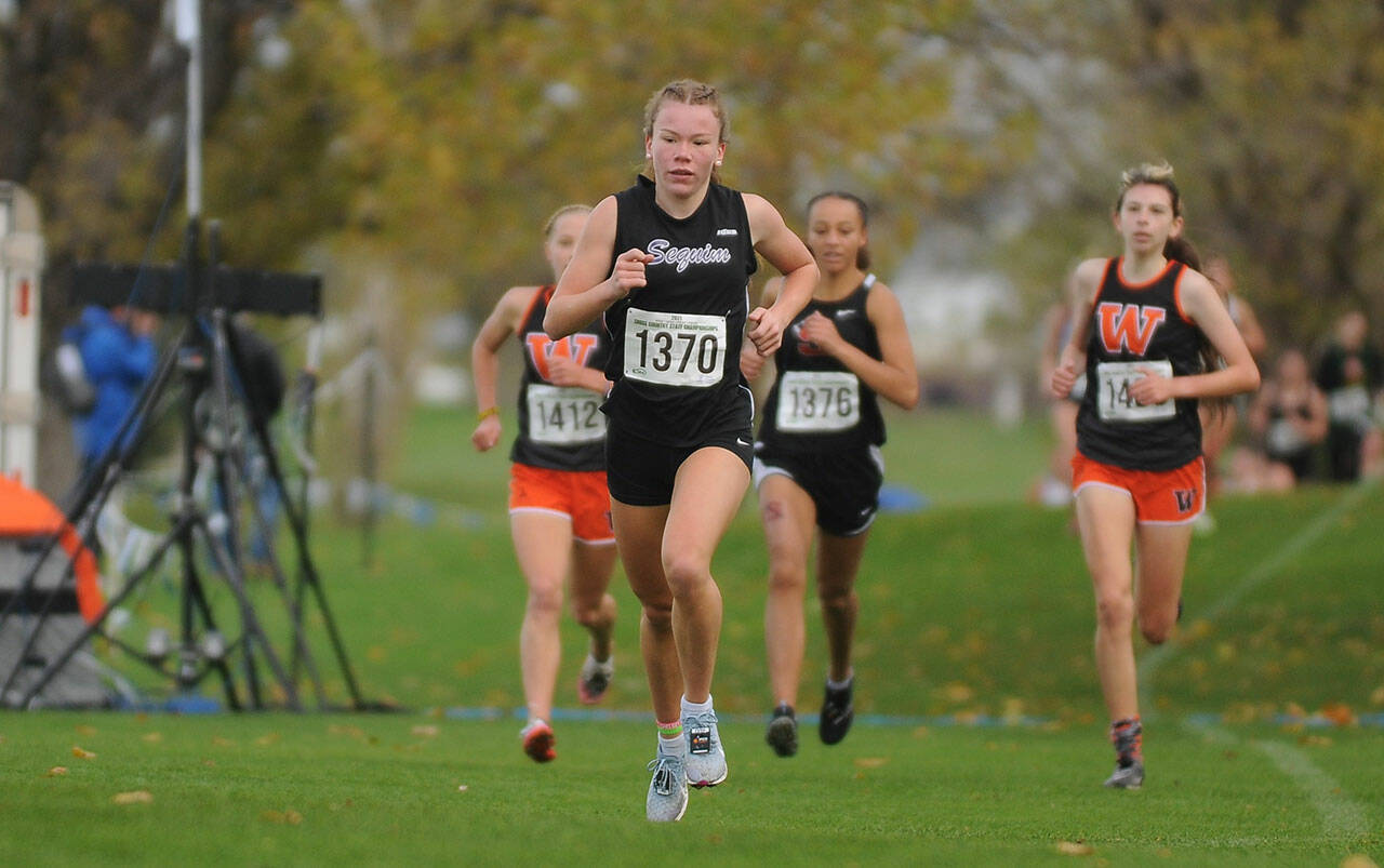 Sequim High senior Riley Pyeatt keeps pace with the lead pack in the opening mile of the class 2A state cross country championship meet in Pasco on Nov. 6. Pyeatt earned her second top-10 finish of her prep career, placing fifth overall. Sequim Gazette photos by Michael Dashiell