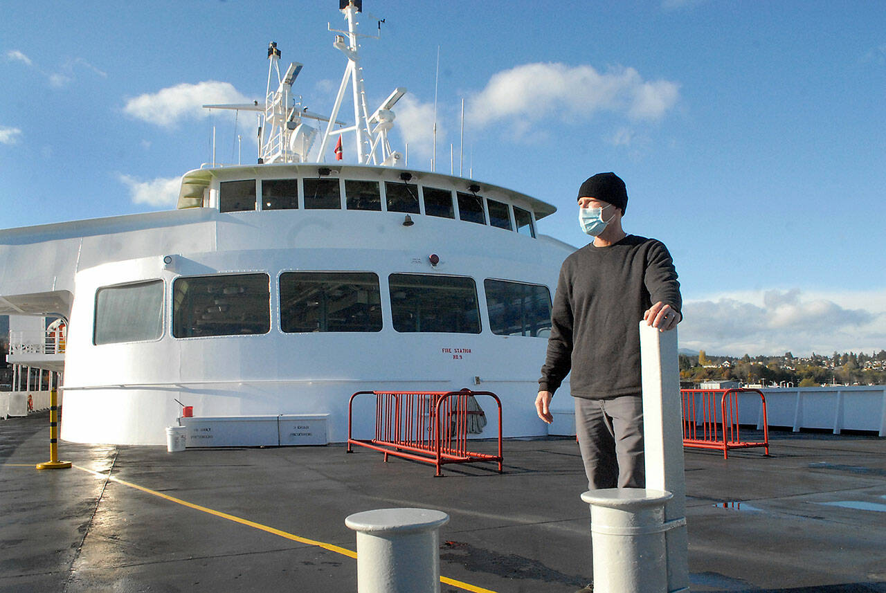 Rian Anderson, Port Angeles district manager for Black Ball Ferry Line, stands on the forward deck of the MV Coho, which resumed daily journeys across the Strait of Juan de Fuca on Nov 8 — 20 months after it was docked by international border restrictions due to COVID-19. Photo by Keith Thorpe/Olympic Peninsula News Group