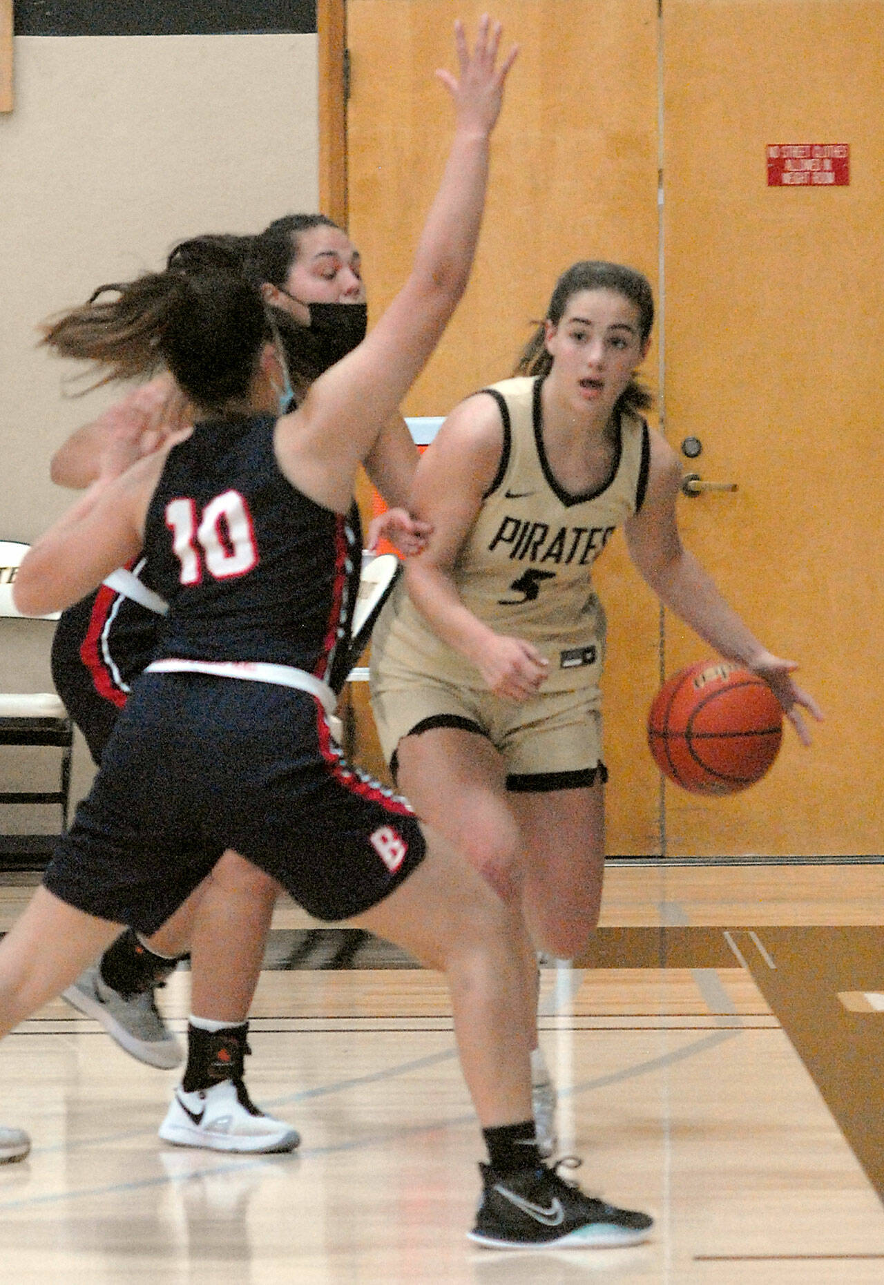 Peninsula’s Hope Glasser, a Sequim High grad, right, fends of the defense of Bellevue’s Mo Bungay, front, and Mckayla Rodriguez during the Pirates’ 2020-2021 campaign. Glasser is one of six local products on the PC roster this season. File photo by Keith Thorpe/Olympic Peninsula News Group