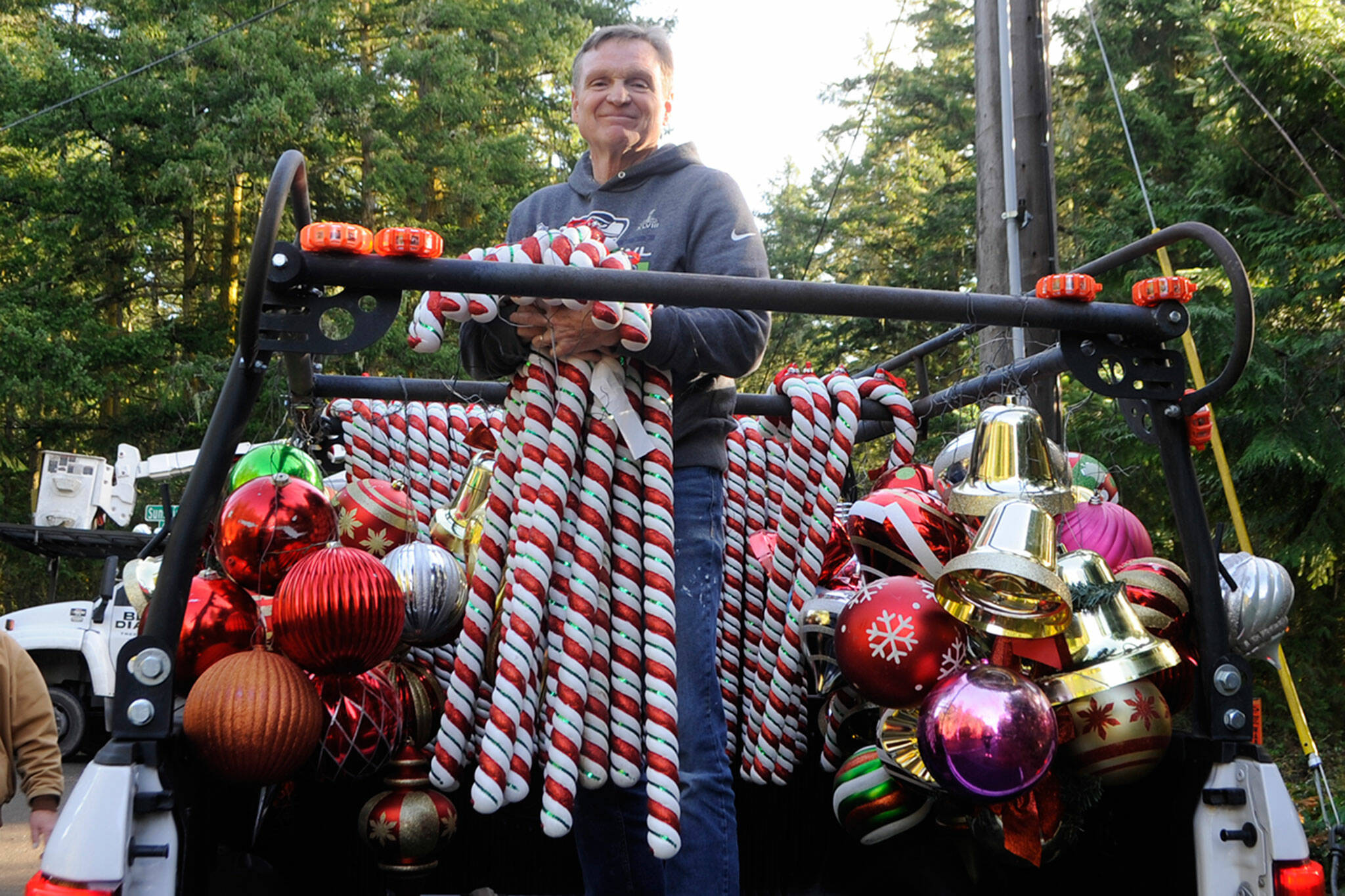 Craig Tenhoff readies to hand off candy canes to place along Diamond Point Road last Saturday. Sequim Gazette photo by Matthew Nash