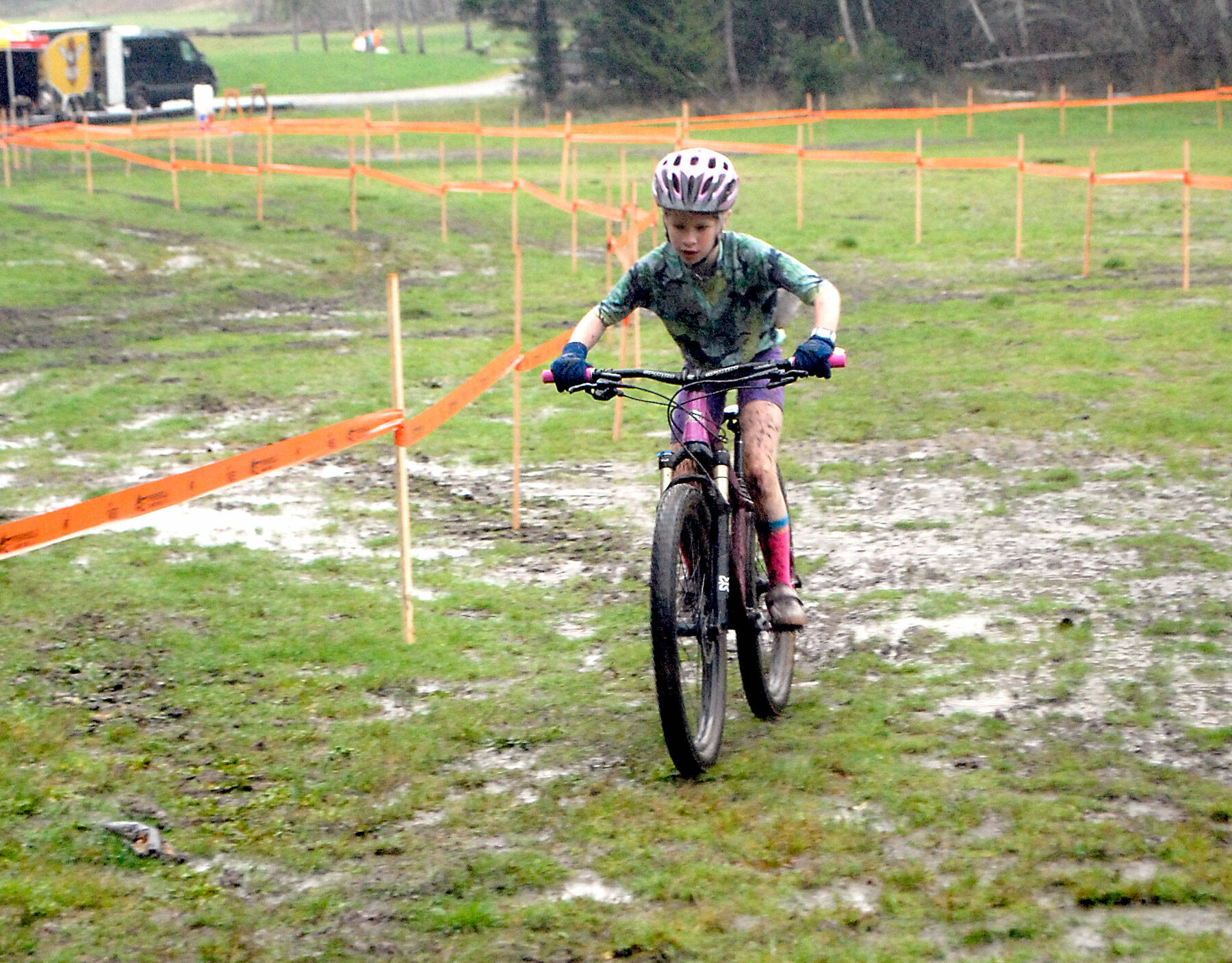 Eleanor Jones of Sequim races through a muddy bog at the Extreme Sports Park in Port Angeles on Nov. 28, as she competes in the the inaugural Extreme CX Port Angeles cyclocross event. Cyclocross, a popular sport in Europe, requires competitors to ride through mud, up steep hills and over obstacles and stairs. Riders often have to pick up their bikes and carry them through “portage” areas where the obstacles are too steep or the mud too slick to ride through. Riders from as young as 10 to as old as 65-plus competed in the late November event, with 94 riders on Nov. 27 and 104 riders the following day. Photo by Keith Thorpe/Olympic Peninsula News Group