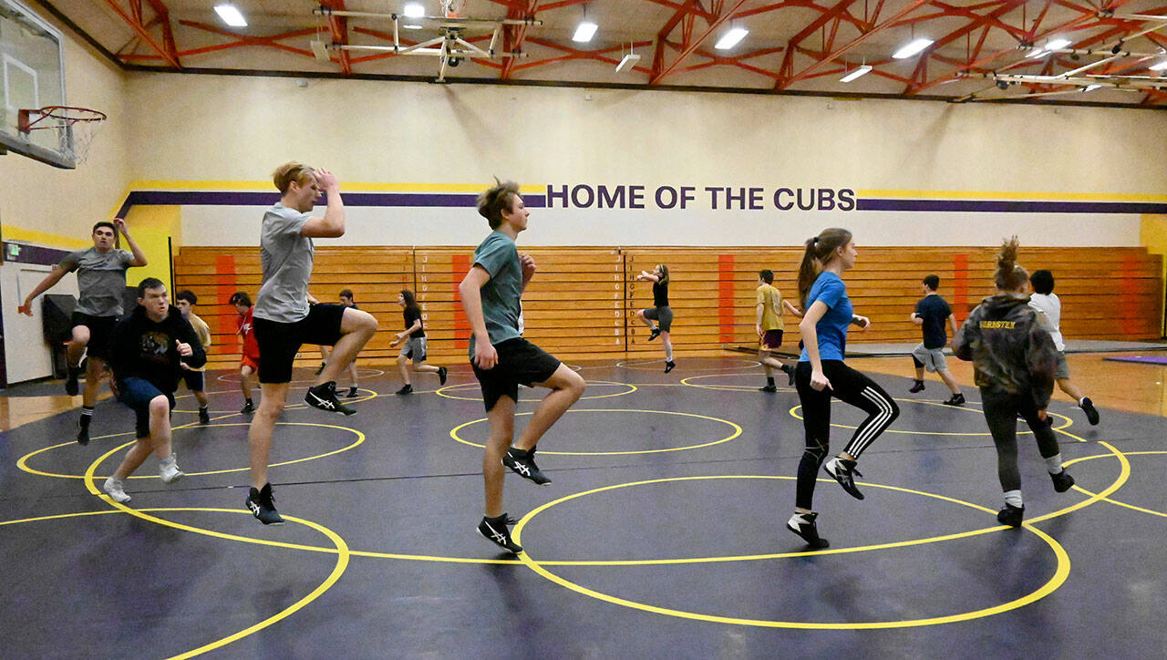 Sequim High wrestlers warm up in a practice at the old Sequim Community School gymnasium last week. The Wolves return eight grapplers and boast a 17-member roster in 2021-2022. Sequim Gazette by Michael Dashiell