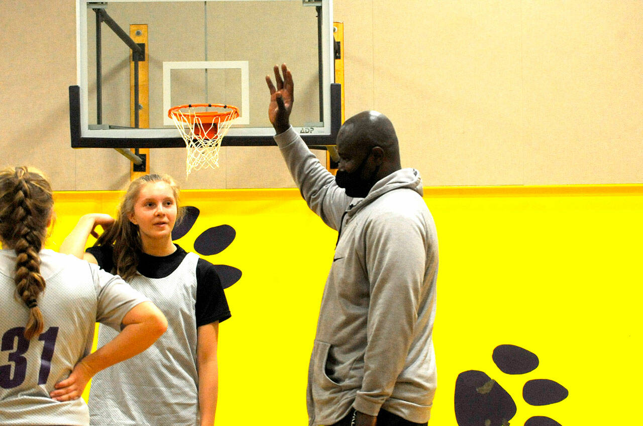 Head Coach Joclin Julmist talks with Jolene Vaara during a recent practice. With limited size on the roster, Julmist said “all the girls work really hard and try to turn teams over to get easy baskets.” Sequim Gazette photo by Matthew Nash