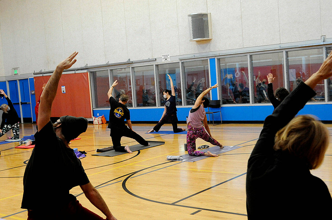Kitty Sokkappa leads a yoga class on Tuesday morning in the YMCA of Sequim. It’s one of the biggest at the facility, staff say. Starting Jan. 1, club members and participants ages 12 and up must provide proof of COVID-19 vaccine or a negative test for the virus before participating in events. 
Sequim Gazette photo by Matthew Nash