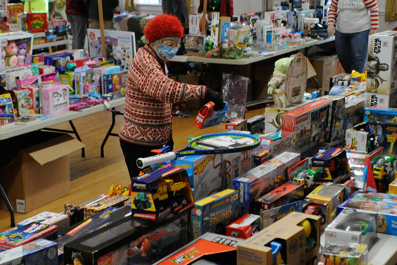 Pat Gritman sorts some of the toys for boys on Dec. 15 inside the Sequim Prairie Grange for Toys for Sequim Kids, an annual event that offers toys, blankets, clothes and more for any child up to 18. Sequim Gazette photo by Matthew Nash