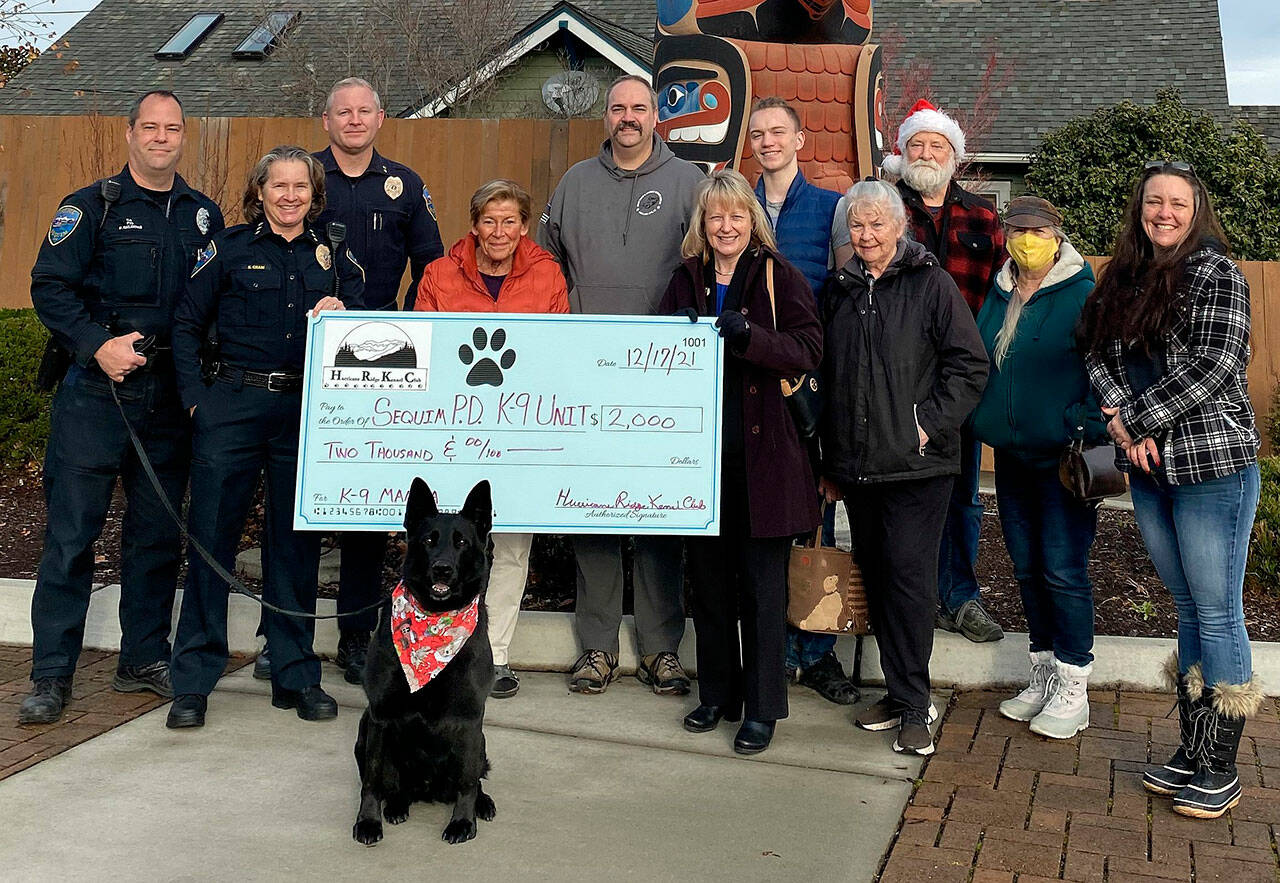 Pictured, from left, are: Paul Dailidenas, Sequim Police Department K9 handler; police chief Sheri Crain; Deputy Chief Mike Hill; and Hurricane Ridge Kennel Club members Jan Garrison, Ben Andrews, Lorraine Shore, Ryan Andrews, Carolyn Money, Joe Metz, Lydia Samperi and Mary Kniskern. Submitted photo