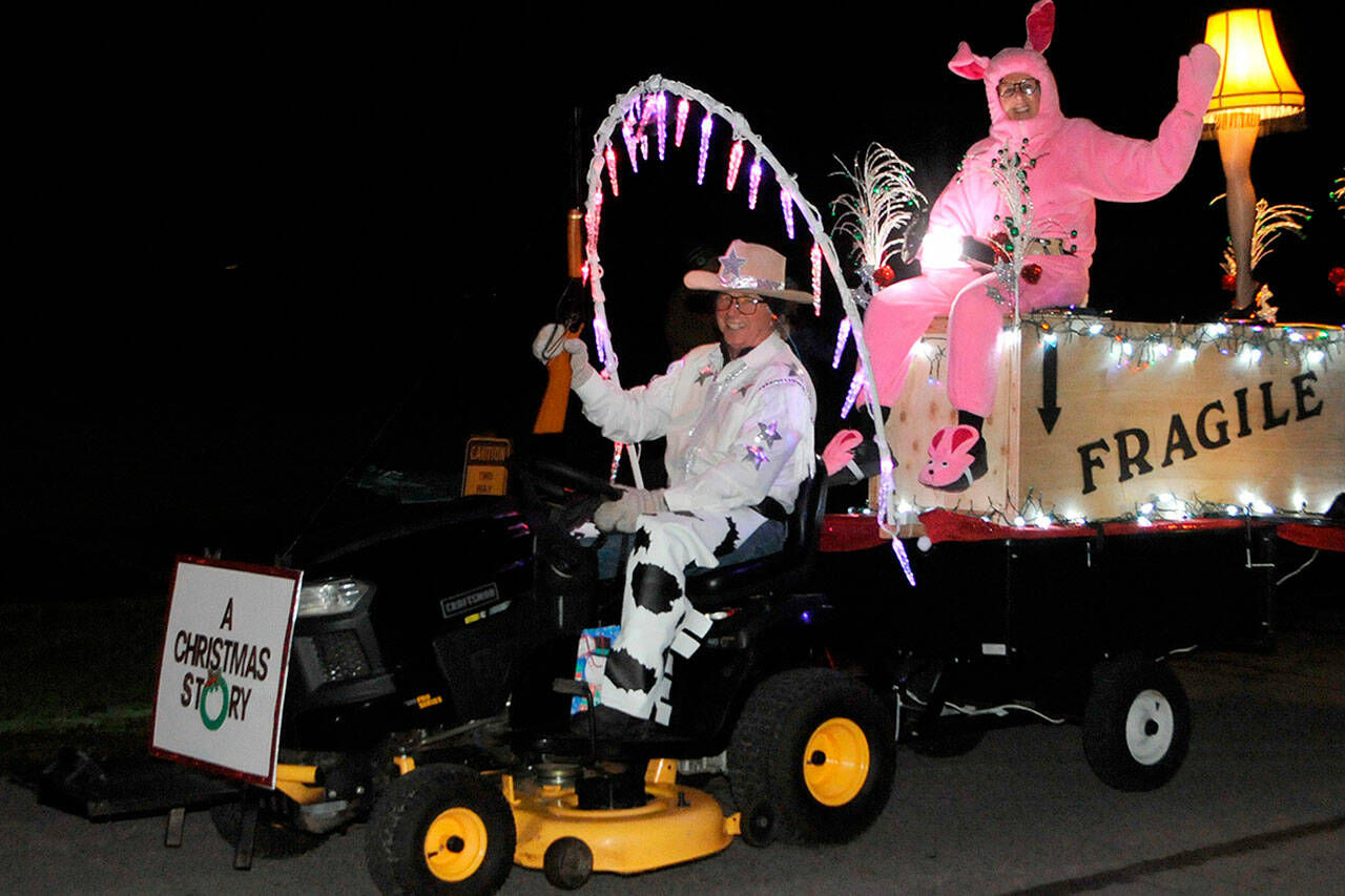 Gary and Sylvia Stanton ride through Sunland on their “A Christmas Story” float on Dec. 19. Sequim Gazette photo by Matthew Nash