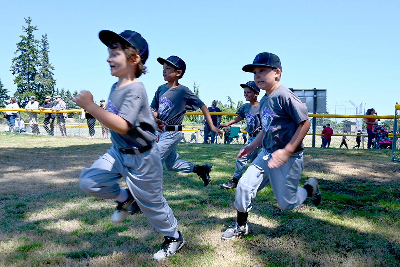 Sequim Gazette file photo by Michael Dashiell
Sequim youngsters race onto the field at the end-of-the-season ceremony at at the James Standard Park fields on July 10. Early bird registration for the 2022 season ends Dec. 31.