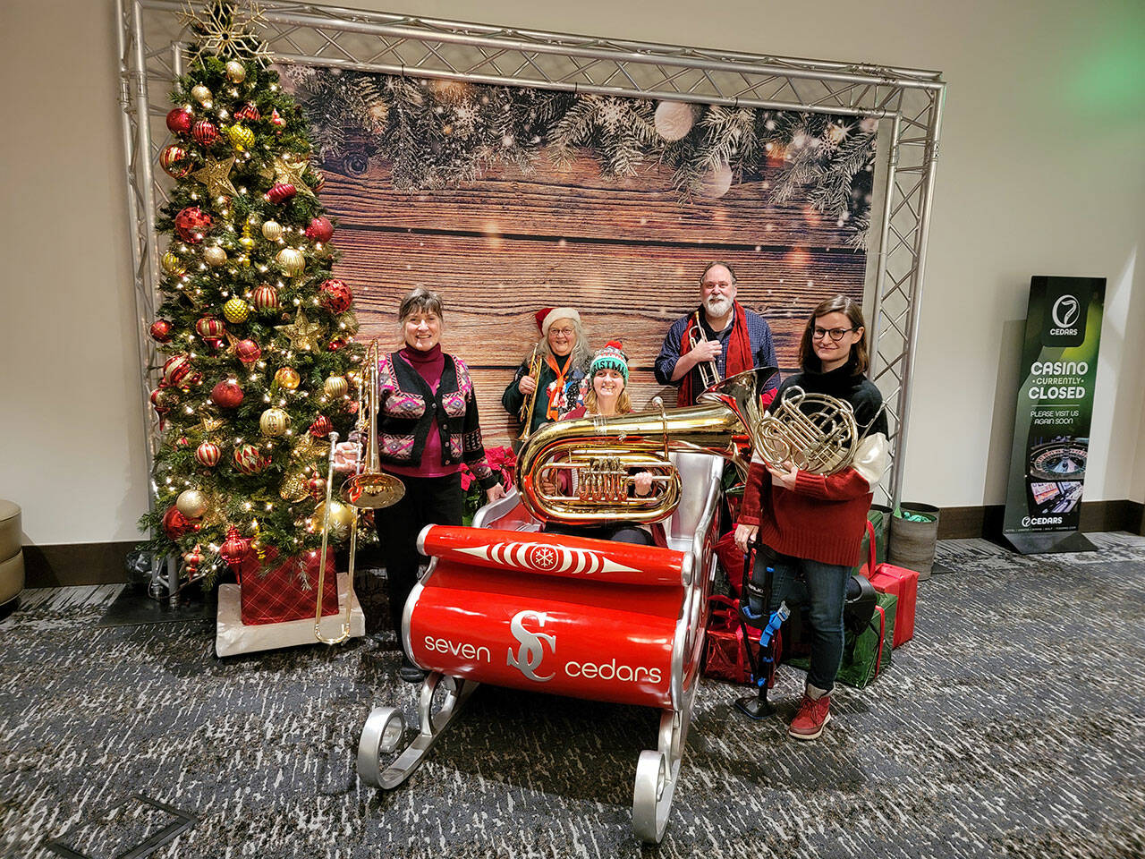 The Sequim City Band Brass Quintet taking a break from playing in Santa's sleigh at 7 Cedars Hotel on Dec. 18. Musicians include: Cindy MacKay, trombone; Cheryl Smoker, trumpet; Hannah Reed, tuba; Jim Bradbury, trumpet, and Kat Creekmore, French horn. Photo by Dave Proebstel