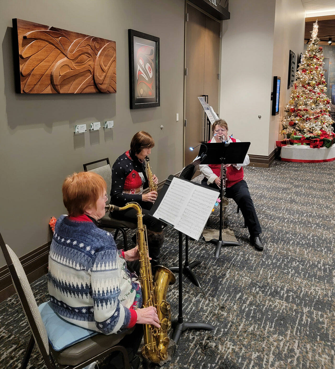 Sequim City Band Sax Duo + One play at 7 Cedars Hotel on Dec. 12. Musicians include: Mary Lowry, tenor saxophone; Debbi Soderstrom, soprano saxophone, and Vicky Blakesley, bass clarinet. Photo by Dave Proebstel
