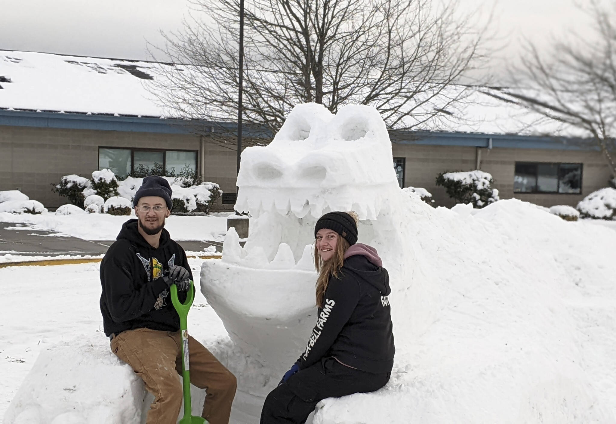 Andrew Lovell and Faith Haggie display a snow creature they created with last week’s snowfall at Greywolf Elementary School in Carlsborg. Photo by Melissa Sanford