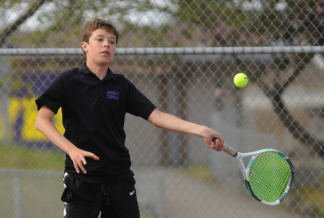Sequim’s Garrett Little, pictured here as a freshman returning a shot against a North Mason foe on May 10, took Olympic League titles twice in 2021. Sequim Gazette photo by Michael Dashiell
