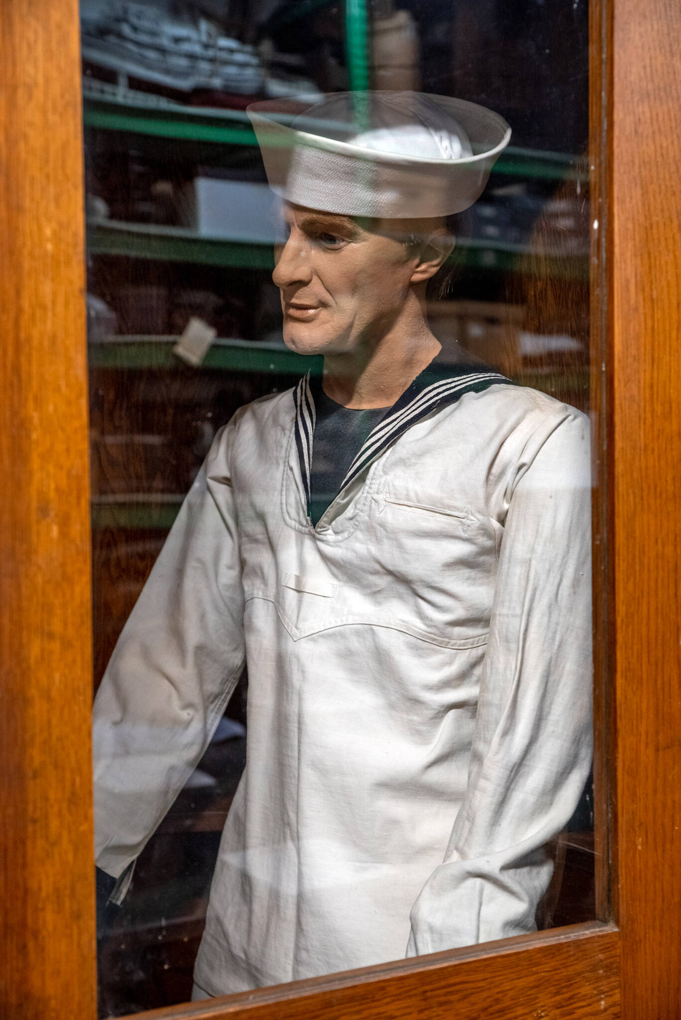 In the archival storage area of the North Olympic History Center, in Port Angeles, a sailor mannequin rests in a booth. Sequim Gazette photo by Emily Matthiessen