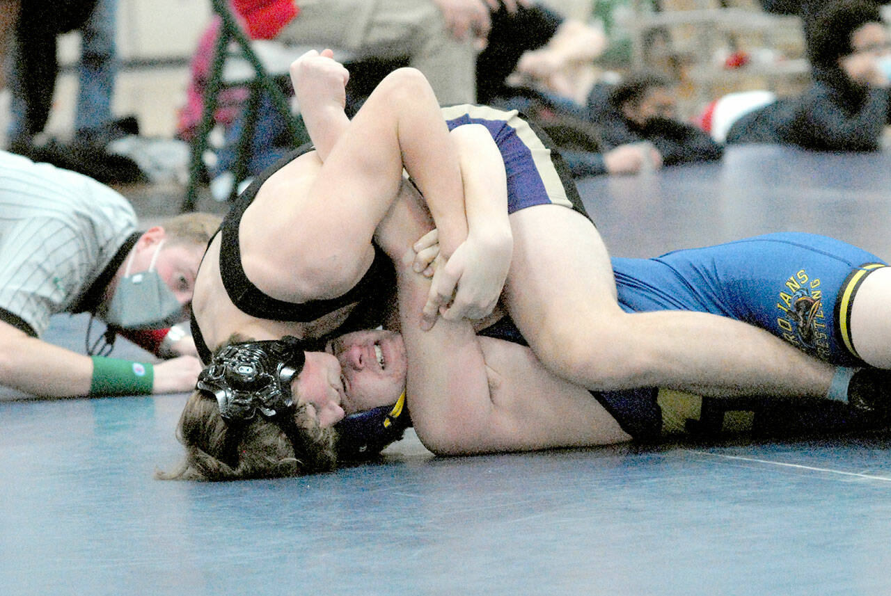 Ari Skov of Sequim, top, takes on Fife’s Cashious Koerth in the 170-pound weight class at the Battle of the Axe on Jan. 8 at Port Angeles High School. Skov won by pin in 1:38.