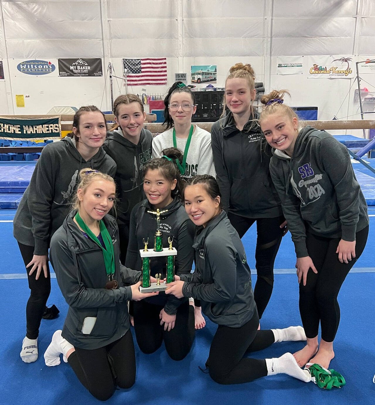 Photo courtesy of Jackie Mangano
The combined Sequim-Port Angeles-Crescent gymnastics team celebrates a second place finish at the Sehome Invitational in Ferndale on Jan. 8. Pictured are (back row, from left) Maddie Adams, Faith Carr, Jessamyn Schindler, Aubrie Scott and Alex Schmadeke, with (front row, from left) Susannah Sharp, Mei-Ying Harper-Smith and Yau Fu.