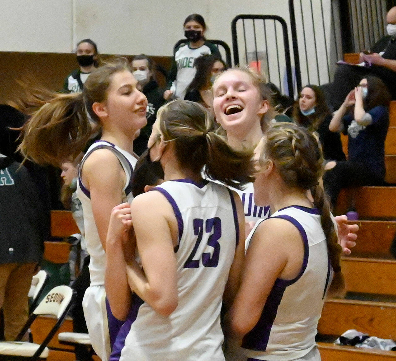 Sequim players celebrate a 60-55 win at home over rival Port Angeles, their first win over the Roughriders in six seasons — ending a 14-game Rider win streak. Sequim Gazette photo by Michael Dashiell