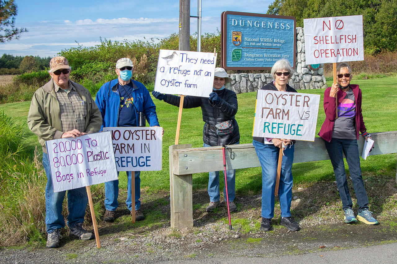 From left, Norm Baker, Jim Karr, Darlene Schanfald, Janet Marx and Jane Erickson gather at the entrance to the Dungeness Wildlife Refuge off Lotzgesell Road in Sequim to protest a future oyster farm planned for the refuge and to hand out fliers of information to people entering the refuge and Dungeness Recreation Area. Sequim Gazette photo by Emily Matthiessen