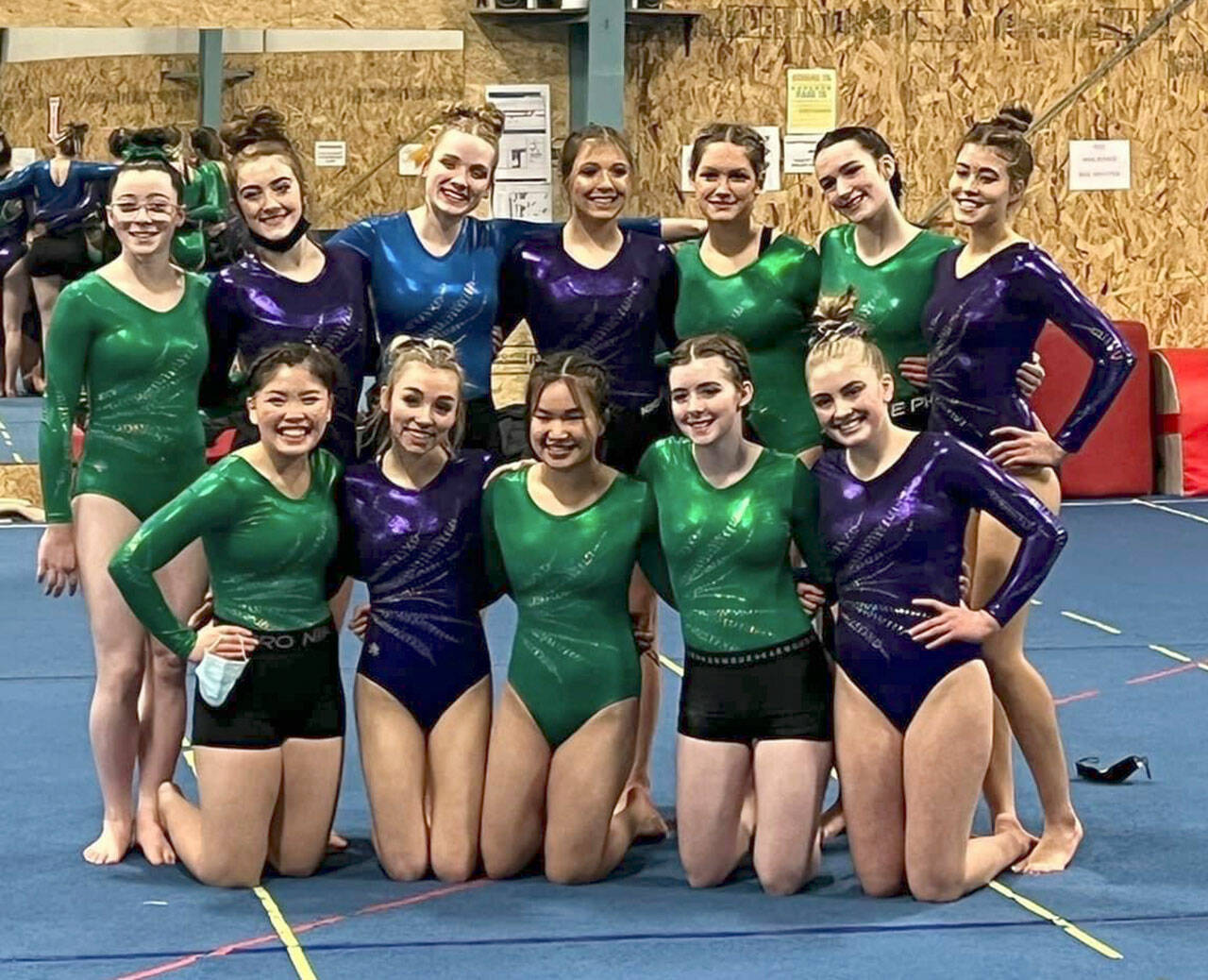 The combined Sequim-Port Angeles-Crescent prep gymnastics team takes a break from competition at the 2A/3A South Sound Conference-Olympic League sub-district meet in Puyallup on Feb. 10. Pictured are (back row, from left) Jessamyn Schindler, Danica Pierson, Aubrie Scott, Ellie Turner, Kathryn Jones, Maddie Adams and Amara Brown, with (front row, from left) Mei-Ying Harper-Smith, Susannah Sharp, Yau Fu, Faith Caar and Alex Schmadeke. Submitted photo