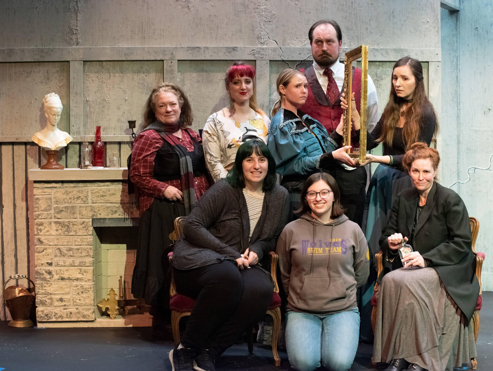 The entire cast of Olympic Theatre Arts’ upcoming production of Angel Street poses for a group picture with director Ginny Holladay, sitting on left and stage manager Madelyn Pickens, kneeling on right. Standing, from left to right are actors Julie Borden, Danielle Kolste, Sierra Brittal, Sean Stone and Angie Roiniotis. On the far right, sitting, is Maude Eisele. Sequim Gazette photo by Emily Matthiessen