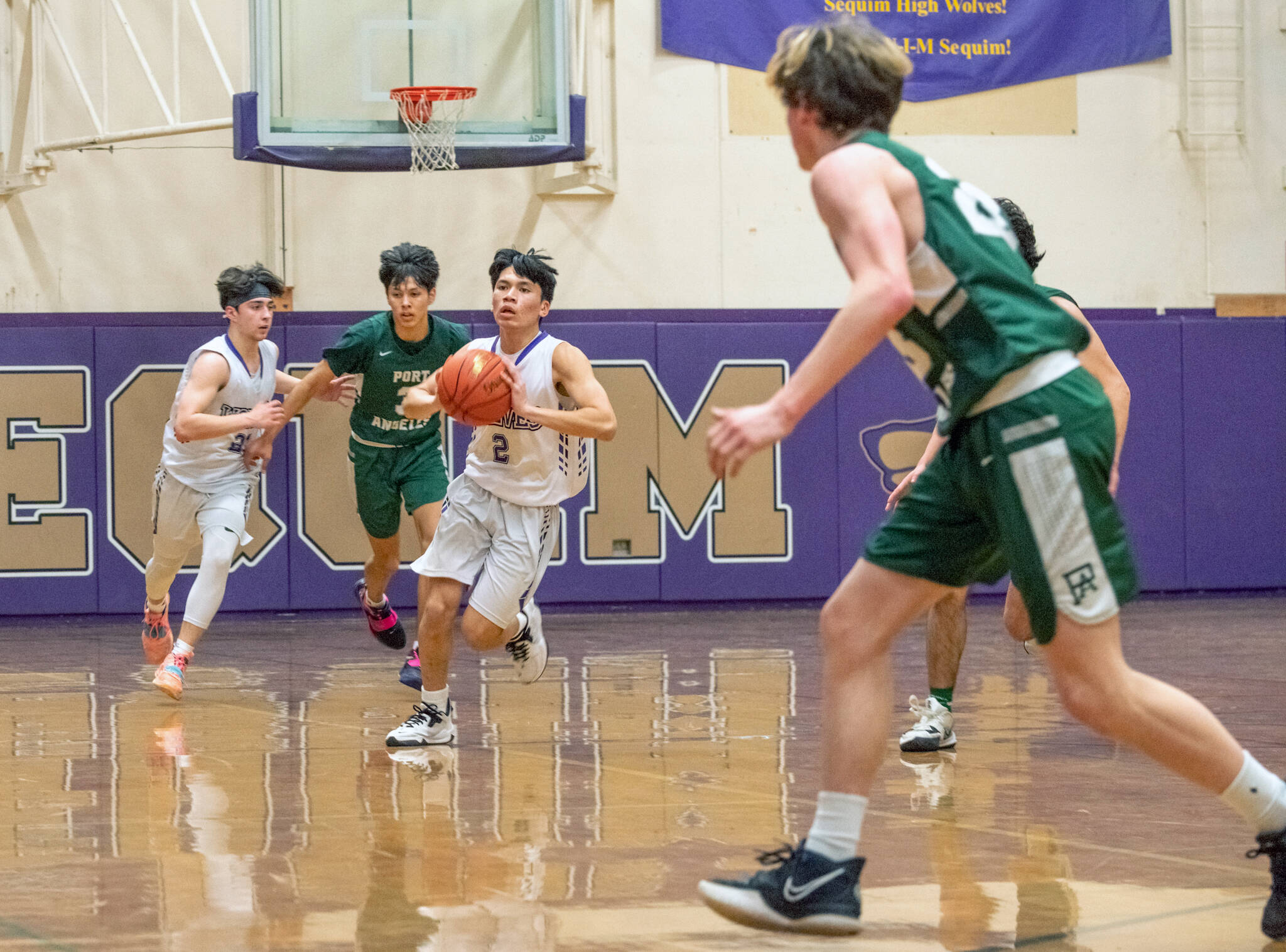 Sequim guard Kristian Mingoy (2) passes to a teammate in the Wolves’ loss to Port Angeles on Feb. 3. Sequim Gazette photo by Emily Matthiessen