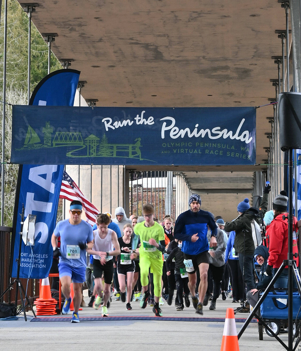 Sequim Gazette photos by Michael Dashiell
Above: Participants break from the starting line at the Elwha Bridge 5k/10k on Feb. 5. Below: Elwha Bridge 5k champ Leia Larson, 13, of Port Angeles, gets congratulated at the finish line as she talks with runner-up Shannon Newman of Maple Valley.