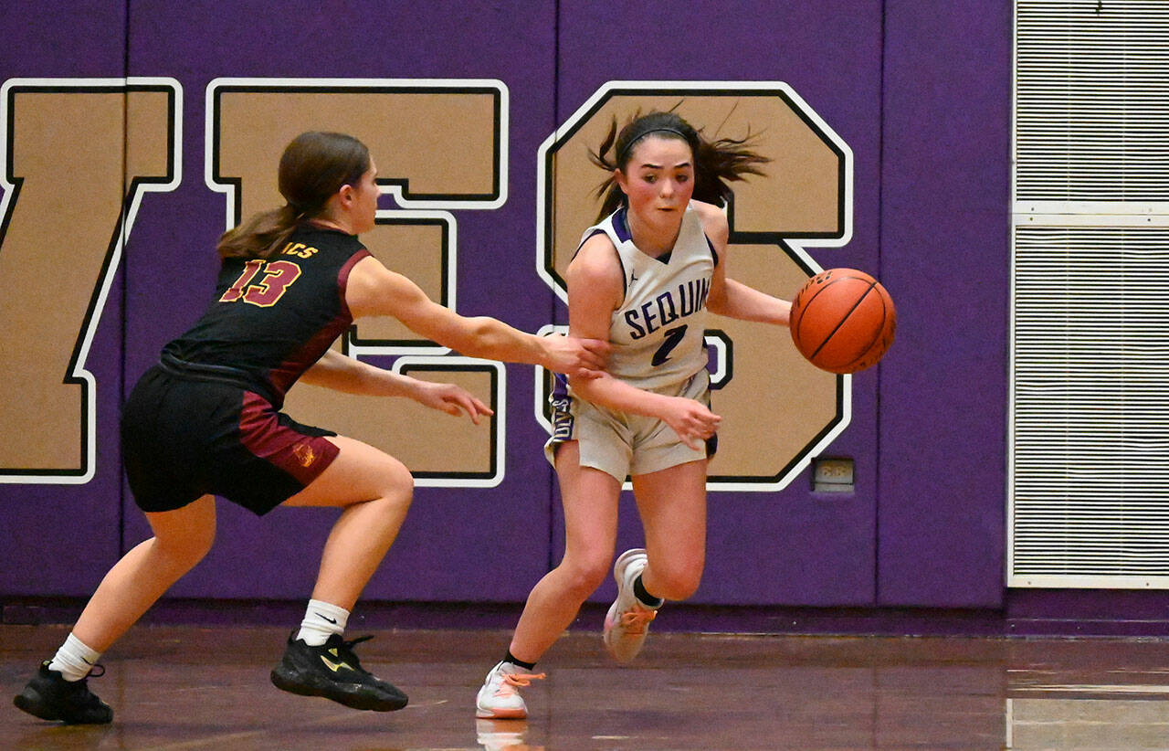 Sequim Gazette photo by Michael Dashiell
Sequim guard Hannah Bates, right, keeps the ball away from Kingston’s Grace Epperson late in the fourth quarter of the Wolves’ 45-41 win on Senior Night, Feb. 8.