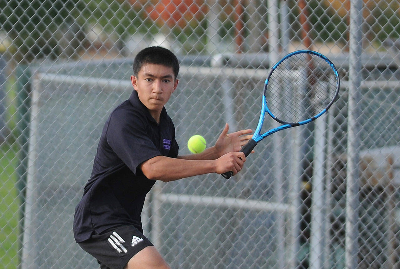 File photo
Sequim’s Koda Robinson looks to hit a backhand in his two-set win over North Kitsap’s Indigo Gallagher in October 2021.