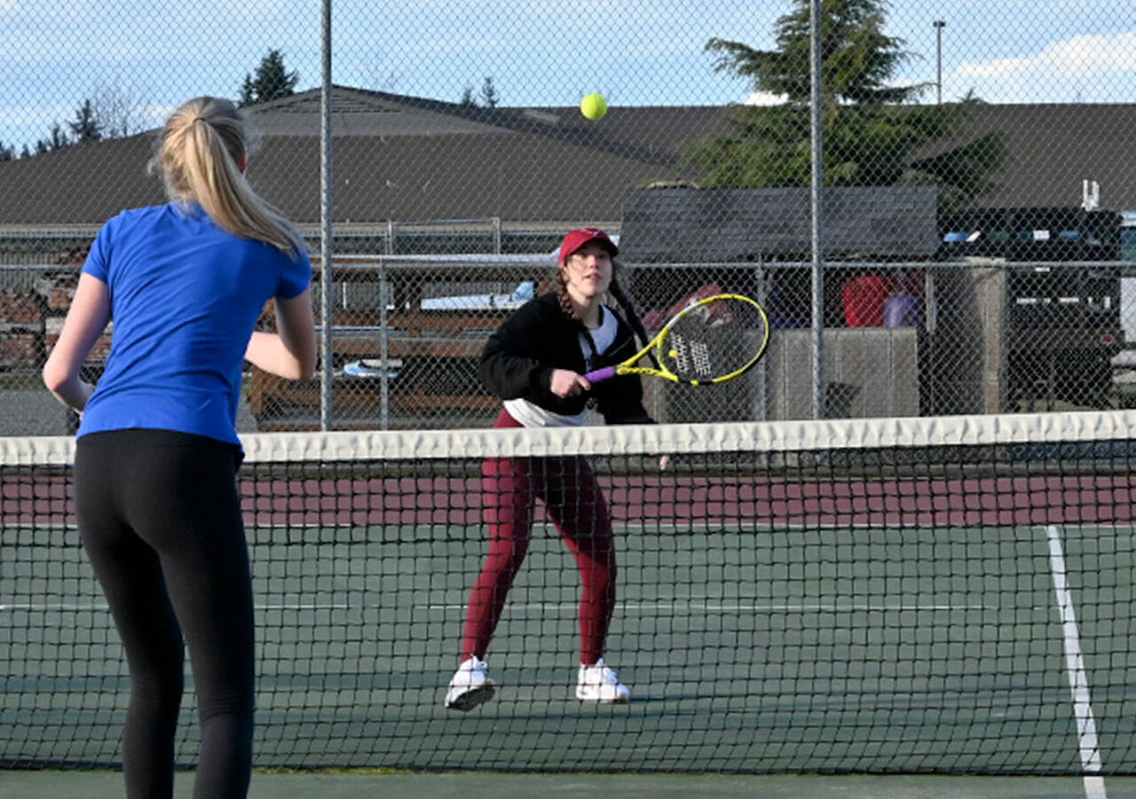 Sequim’s Jordan Hegtvedt, right, works on her net game with teammate Kendall Hastings in a preseason practice last week. Sequim High’s roster this spring features just three returners with varsity experience. Sequim Gazette photo by Michael Dashiell