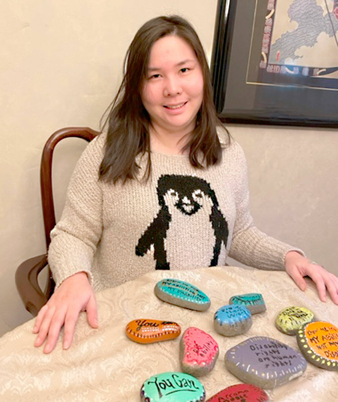 Photo courtesy of Helen Motokane
Christine Motokane displays some of the painted rocks she plans to place in public areas around Sequim and Port Angeles. Motokane is a self-advocate with autism, author of the memoir “Working the Double Shift: A Young Woman’s Journey with Autism,” a college graduate and a paraeducator.