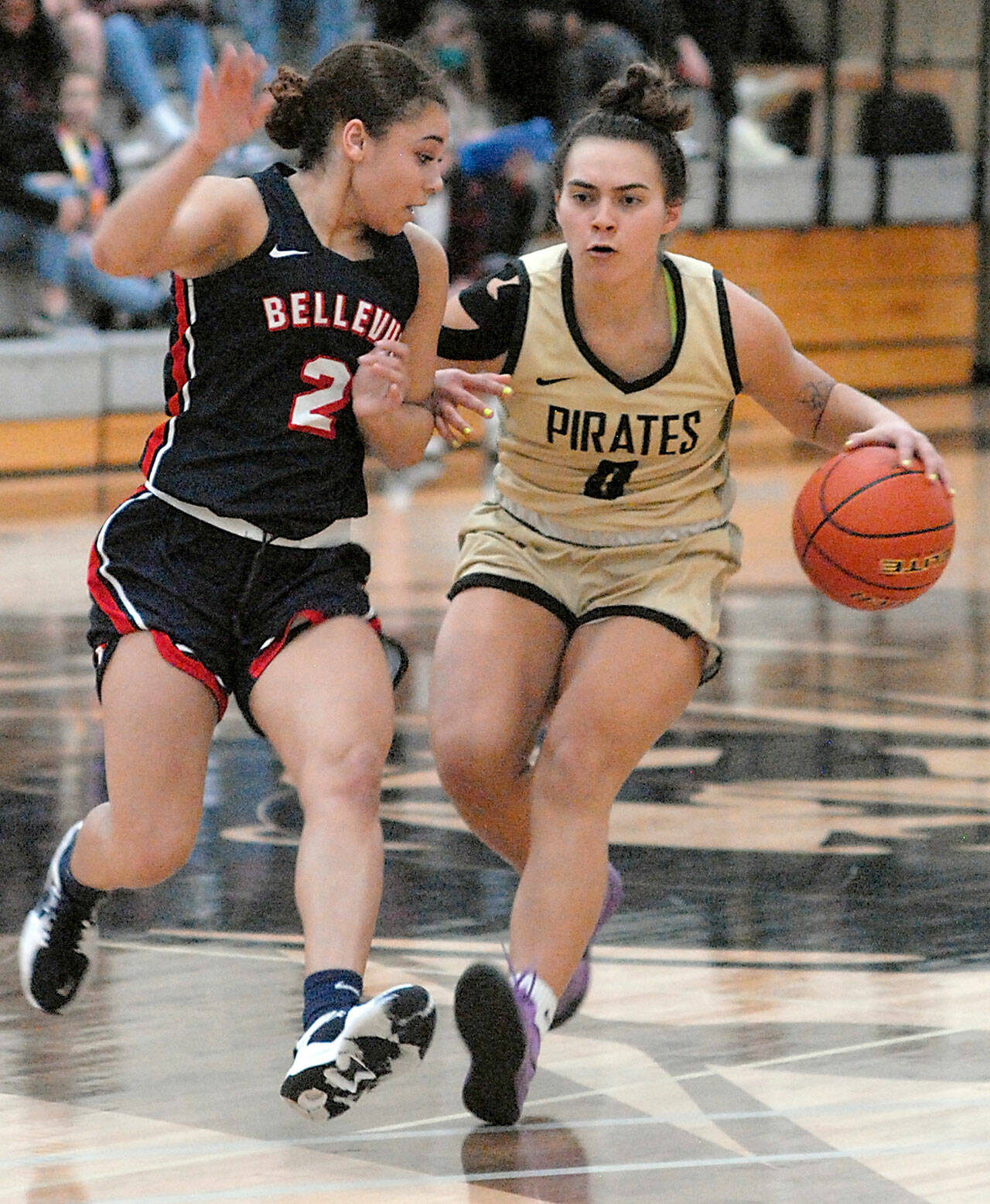 Peninsula’s Keeli-Jade Smith, right, drives past Bellevue’s Alashae Bell on Saturday in Port Angeles. Photo by Keith Thorpe/Olympic Peninsula News Group