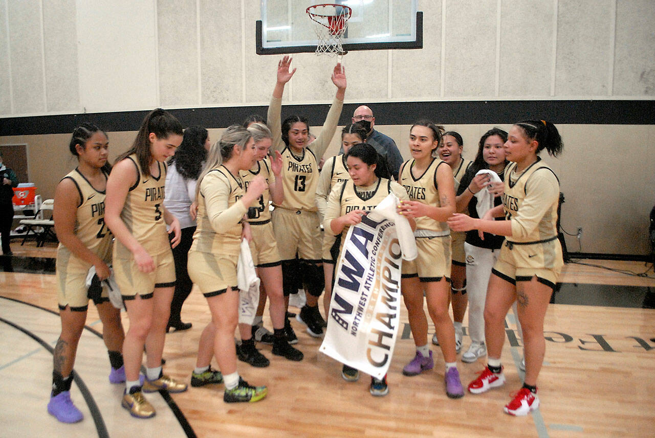 Keith Thorpe | Olympic Peninsula News Group
Members of the Peninsula College womens basketball team celebrate a 67-61 win over Shoreline on March 9 to earn them the NWAC North Region championship. Holding the banner was Ariyanna Camacho-Villafuerte.