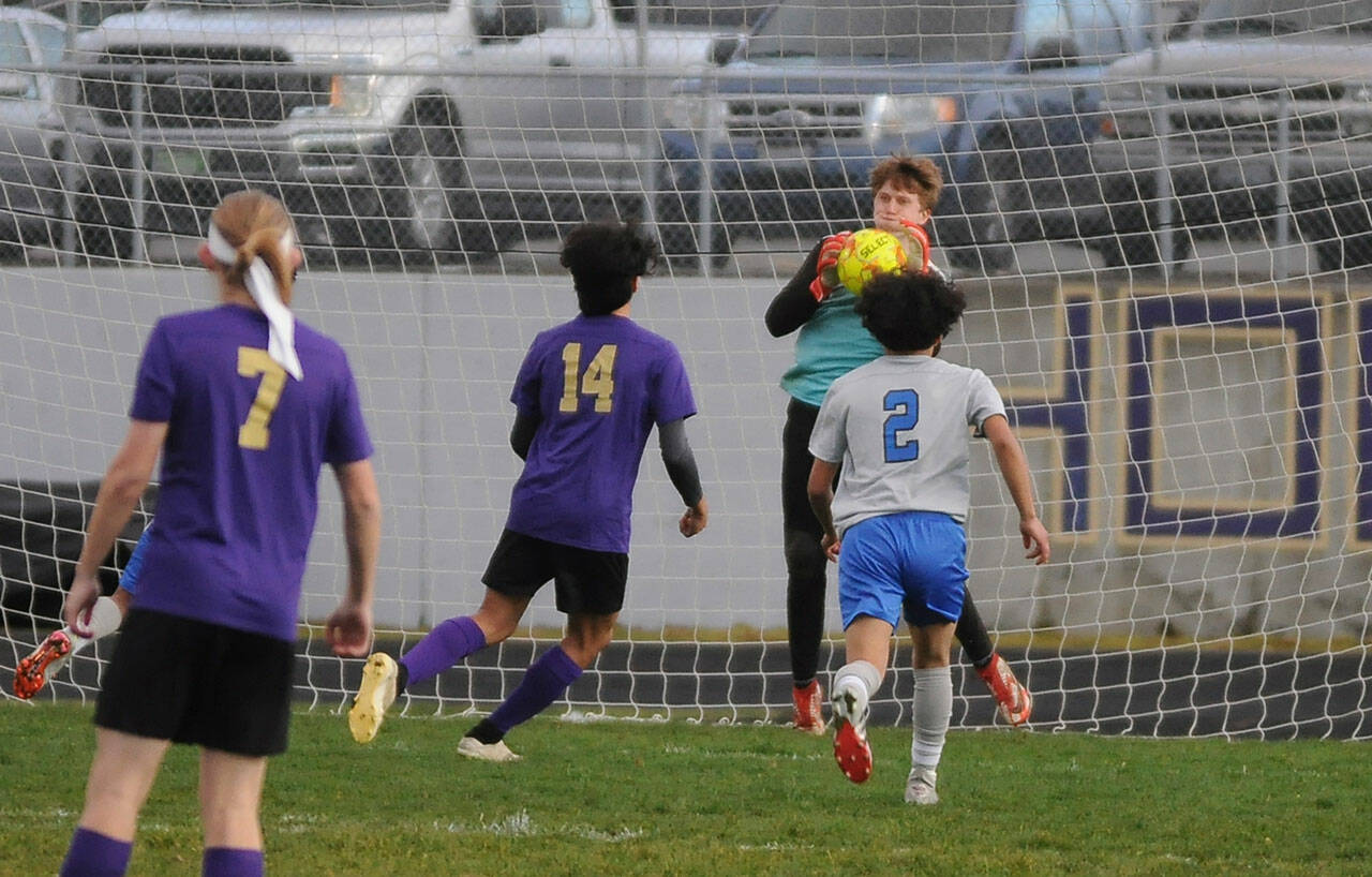Sequim goalkeeper Jack Van De Wege makes a save in the Wolves’ home opener, a 4-0 win over North Mason on March 15. Sequim Gazette file photo by Michael Dashiell