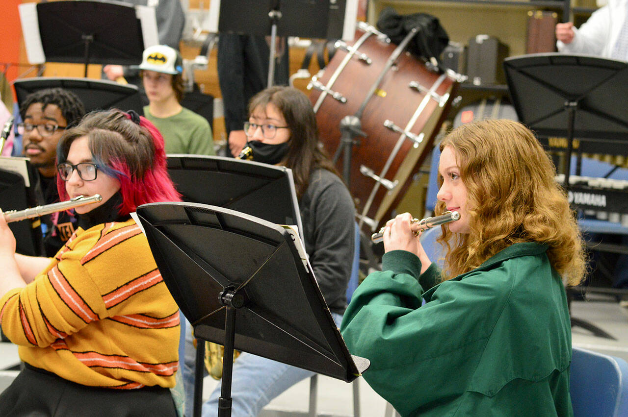 Photo by Diane Urbani de la Paz/Olympic Peninsula News Group
After many months of masking, flutists Gabby Mattern-Hall, left, and Sibyl Finman got to shed their face coverings for band practice in George Rodes’ band room at Sequim High School.