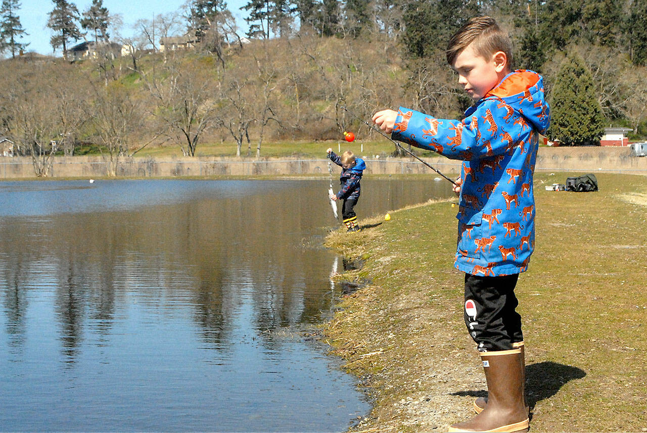 Weston Web, 6, prepares to cast a line at the children’s fishing pond at the Water Reuse Demonstration Site next to Carrie Blake Community Park in March 2021, as his brother, Bennet, 4, tends to a freshly caught fish. The Puget Sound Anglers-North Olympic Peninsula Chapter hosts its annual Kids Fishing Day at the pond on April 23. File photo by Keith Thorpe/Olympic Peninsula News Group