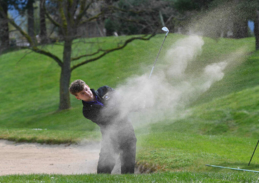 Sequim Gazette photo by Michael Dashiell
Sequim’s Dominic Riccobene hits out of a bunker on the 10th hole as the Wolves take on North Kitsap on April 28.