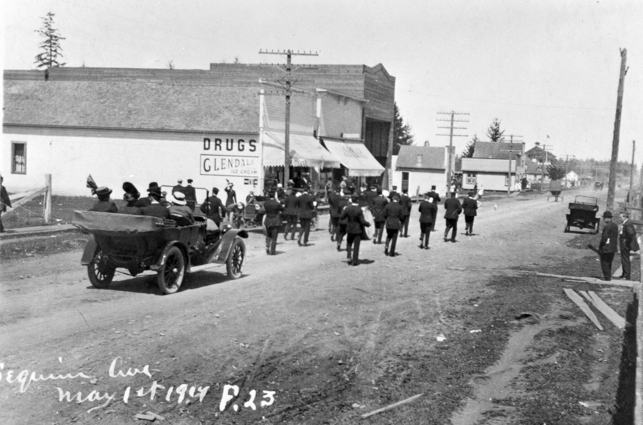 Photo from North Olympic Heritage/Bert Kellogg Photograph Collection
A parade — with an automobile and marching band — moves down Sequim Avenue on May 1, 1914.