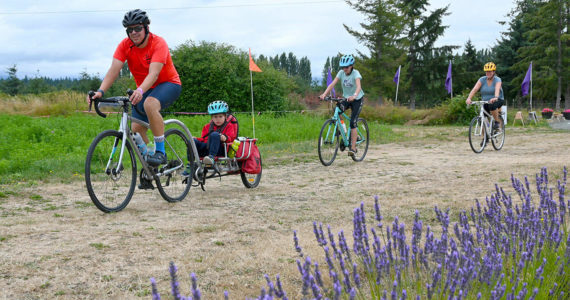 From left, Greg Roe and family — children Andrew, 5, and Charlotee, 11, with wife Bridget McKay — enjoy the Tour de Lavender Fun Ride in 2021. The group was enjoying a day trip from the Lake Stevens area. Sequim Gazette file photo by Michael Dashiell