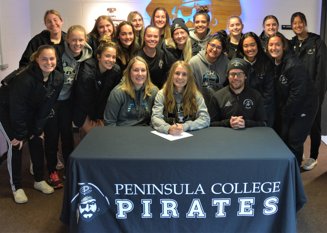 Sequim’s Hannah Wagner, center, signs a letter of intent to play for Peninsula College’s women’s soccer team next season. Photo courtesy of Rick Ross/Peninsula College