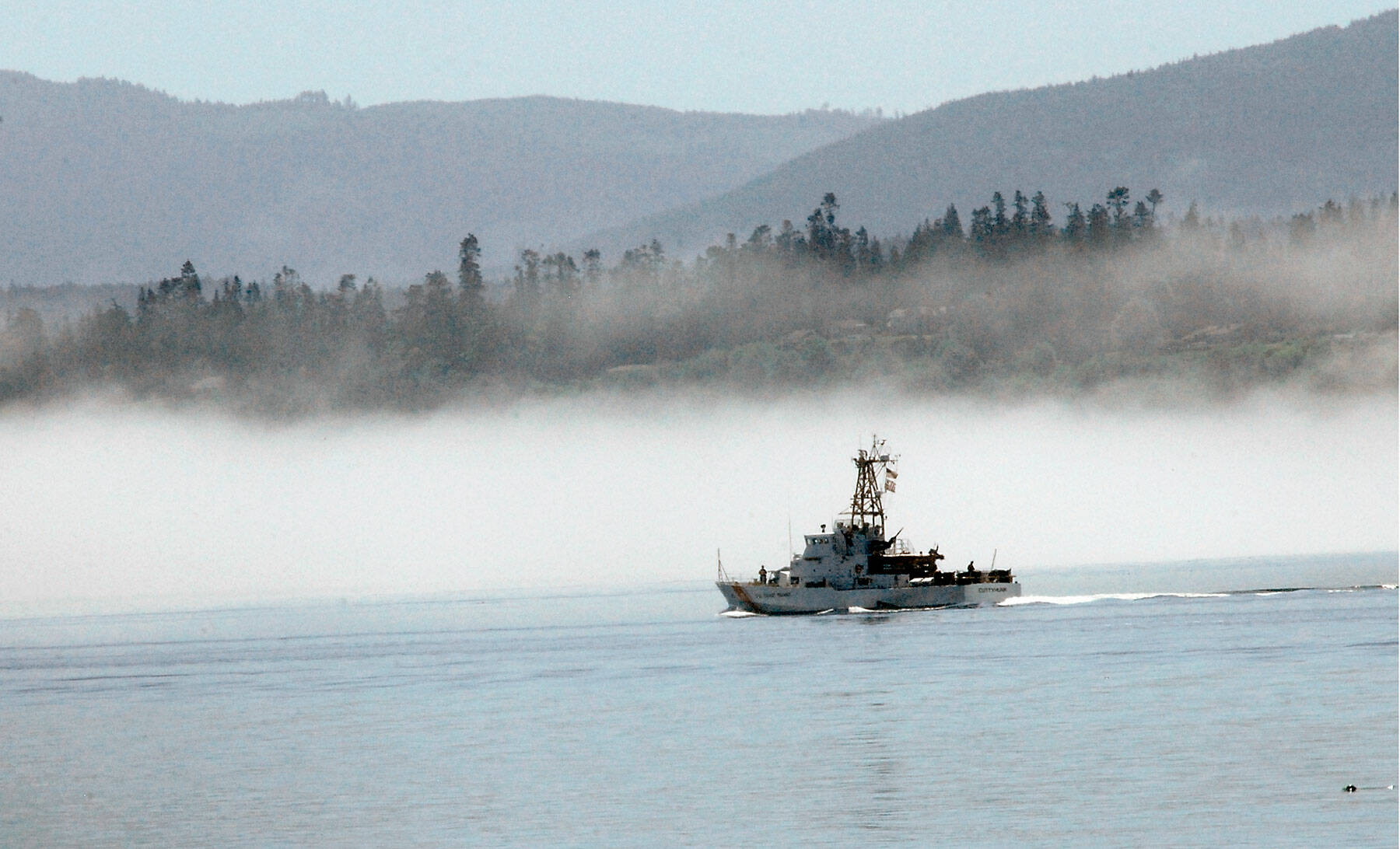 The U.S. Coast Guard cutter Cuttyhunk sails across Port Angeles Harbor against a backdrop of fog hugging the shoreline. in June 2020. Photo by Keith Thorpe/Olympic Peninsula News Group