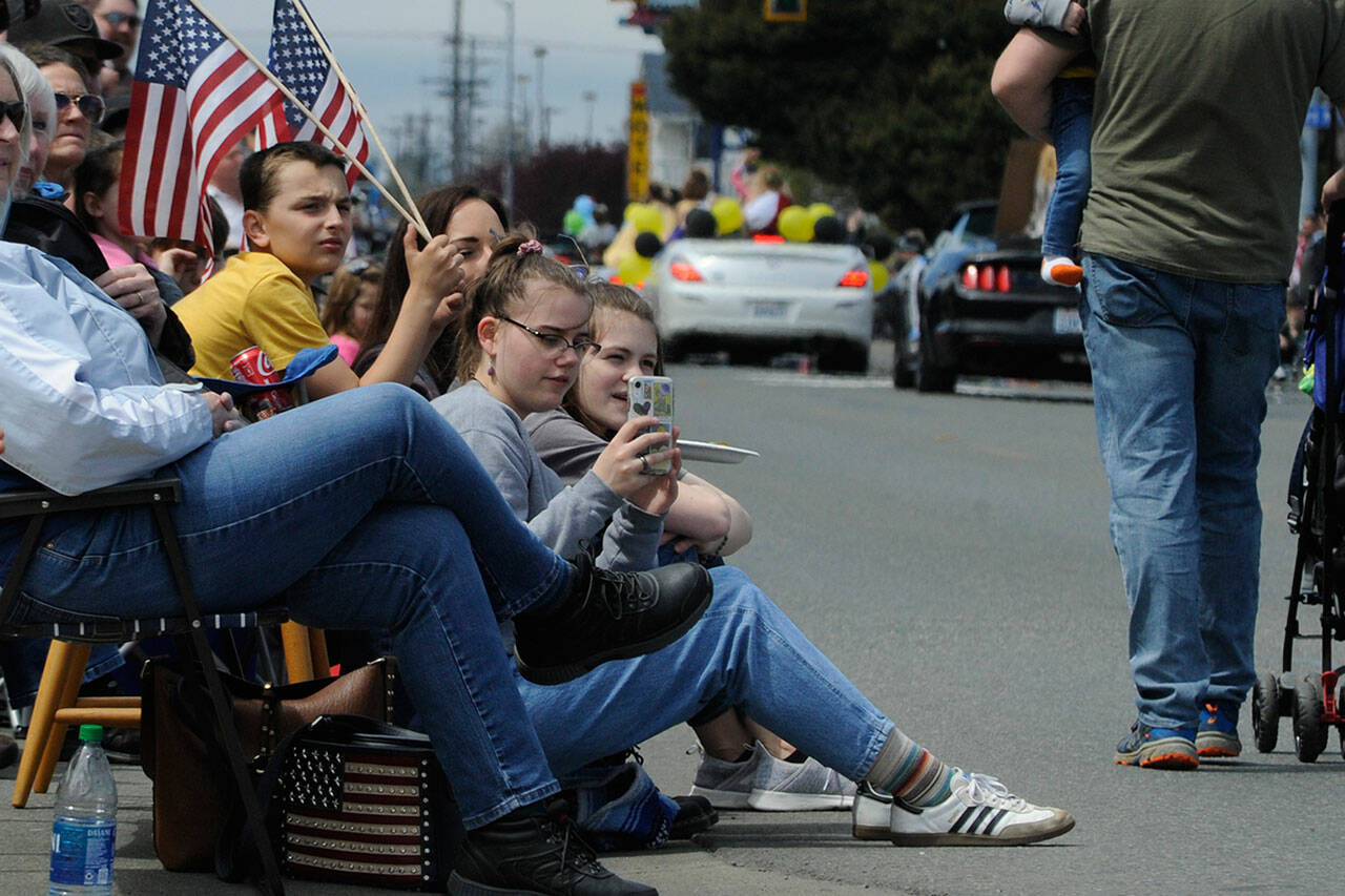 Sequim Gazette photo by Matthew Nash/ Abby Velarde, 15, videos the Grand Parade on Saturday as dignitaries of the Sequim Irrigation Festival roll by.