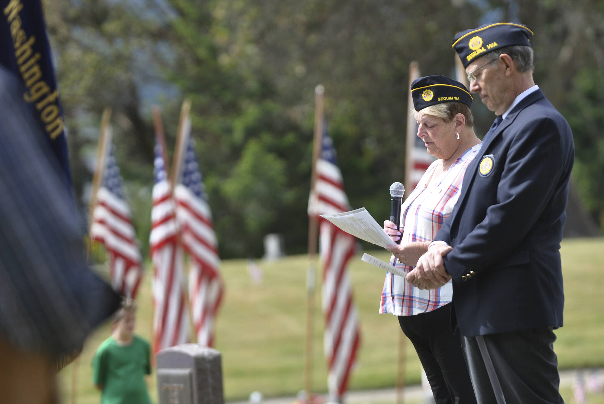 Nancy Zimmermann, chaplain for American Legion Post 62, offers a prayer at the Memorial Day ceremony at Sequim View Cemetery in 2021. At right is Post commander Paul Renick. Sequim Gazette file photo by Michael Dashiell